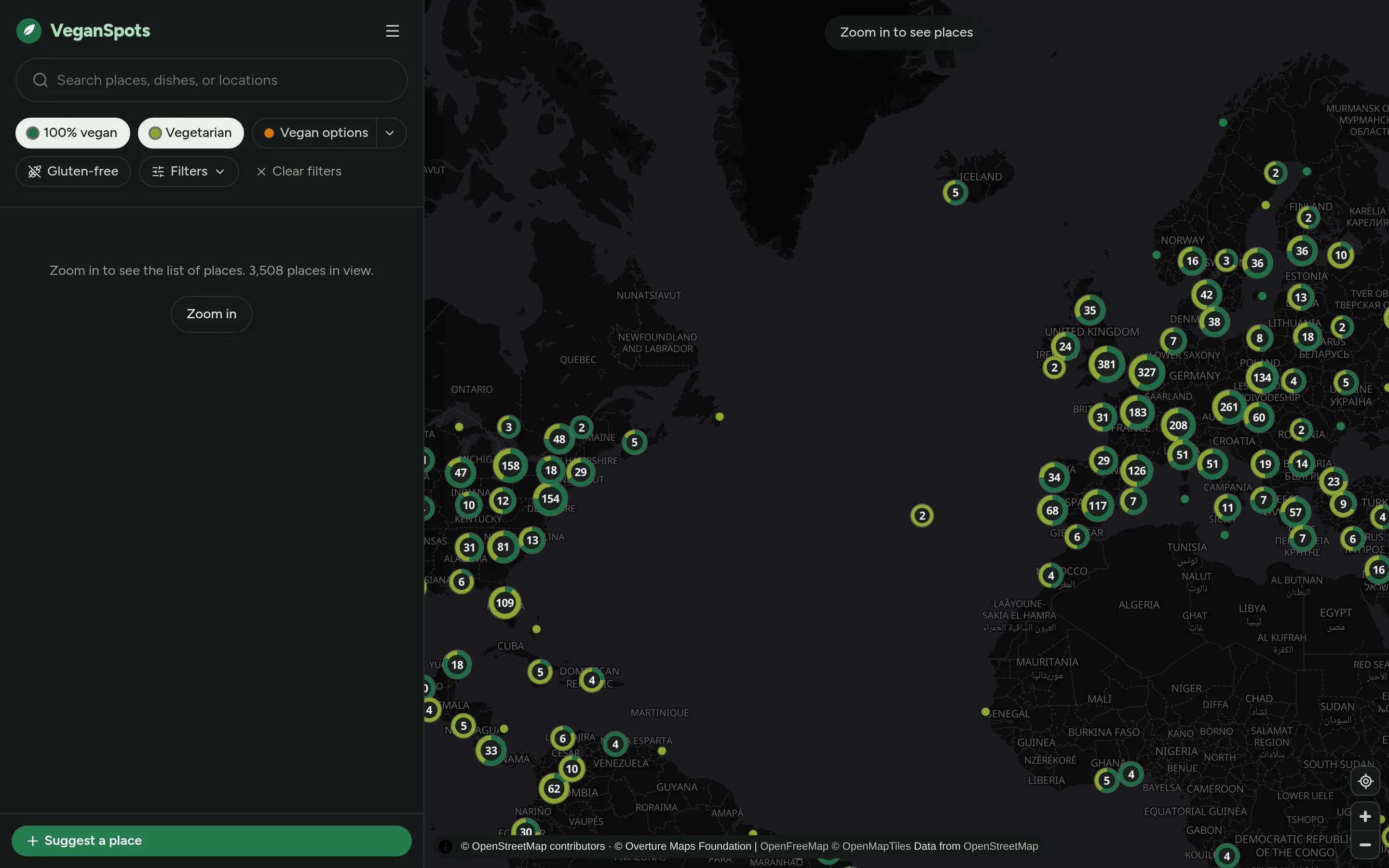 The VeganSpots map zoomed out over eastern North America and Europe, with clusters of 100% vegan and vegetarian places